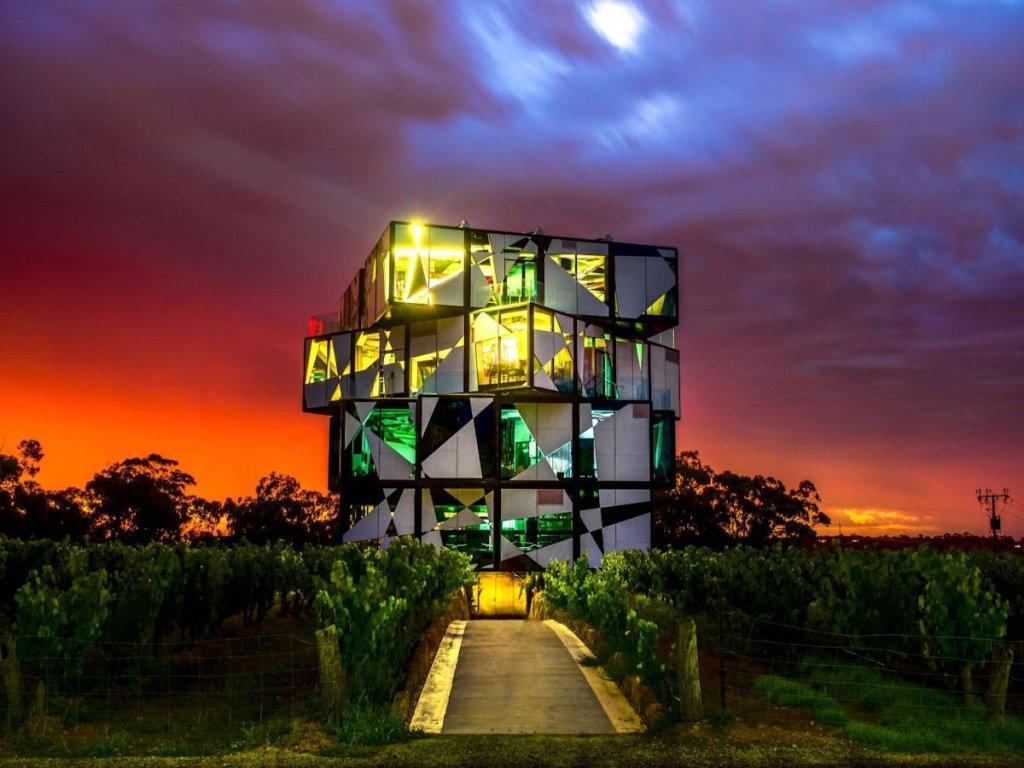 D'Arenberg cube architectural building that looks like a giant Rubik's cube with grape fines in the foreground and beautiful sunset