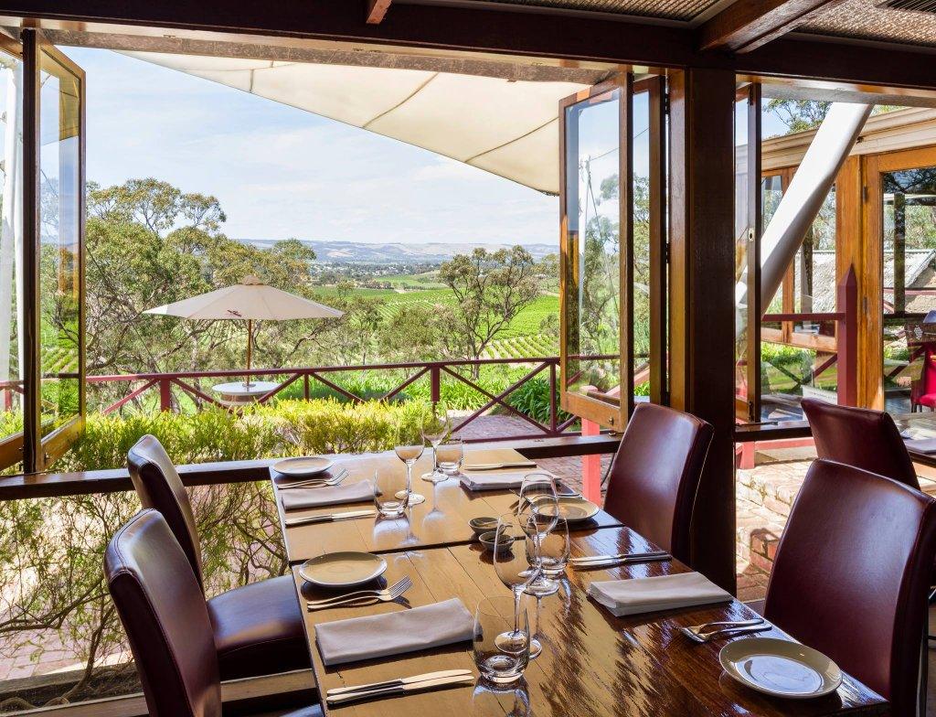 D'Arrys verandah restaurant with set dining table and views accross vineyards