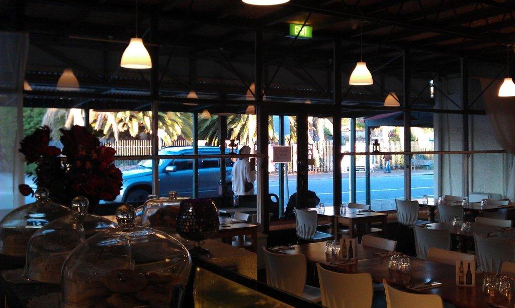 Langs Kitchen small restaurant on main street with tables set and mirror behind tables