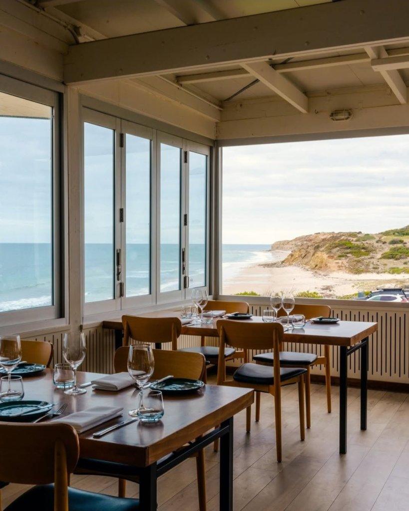 Star of Greece restaurant with dining tables set for service with beautiful beach view in background