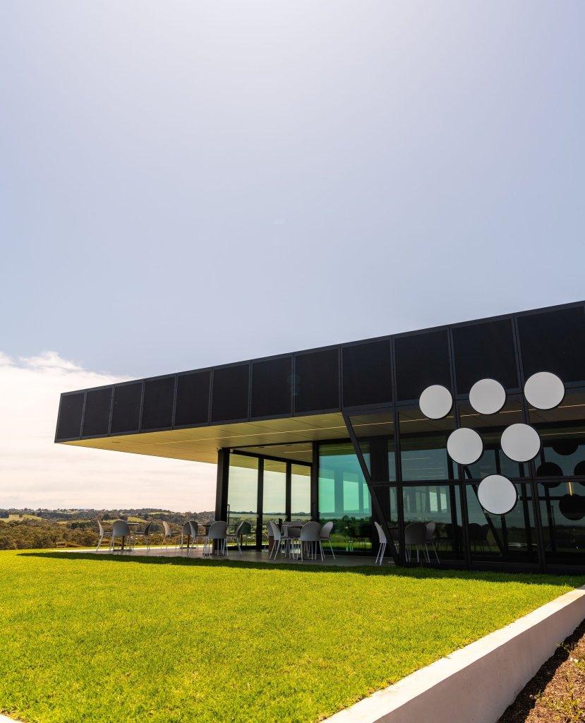 Vale Restaurant and Bar Vale Brewing McLaren Vale Architectural builing with large glass windows and table and. sweeping green lawn