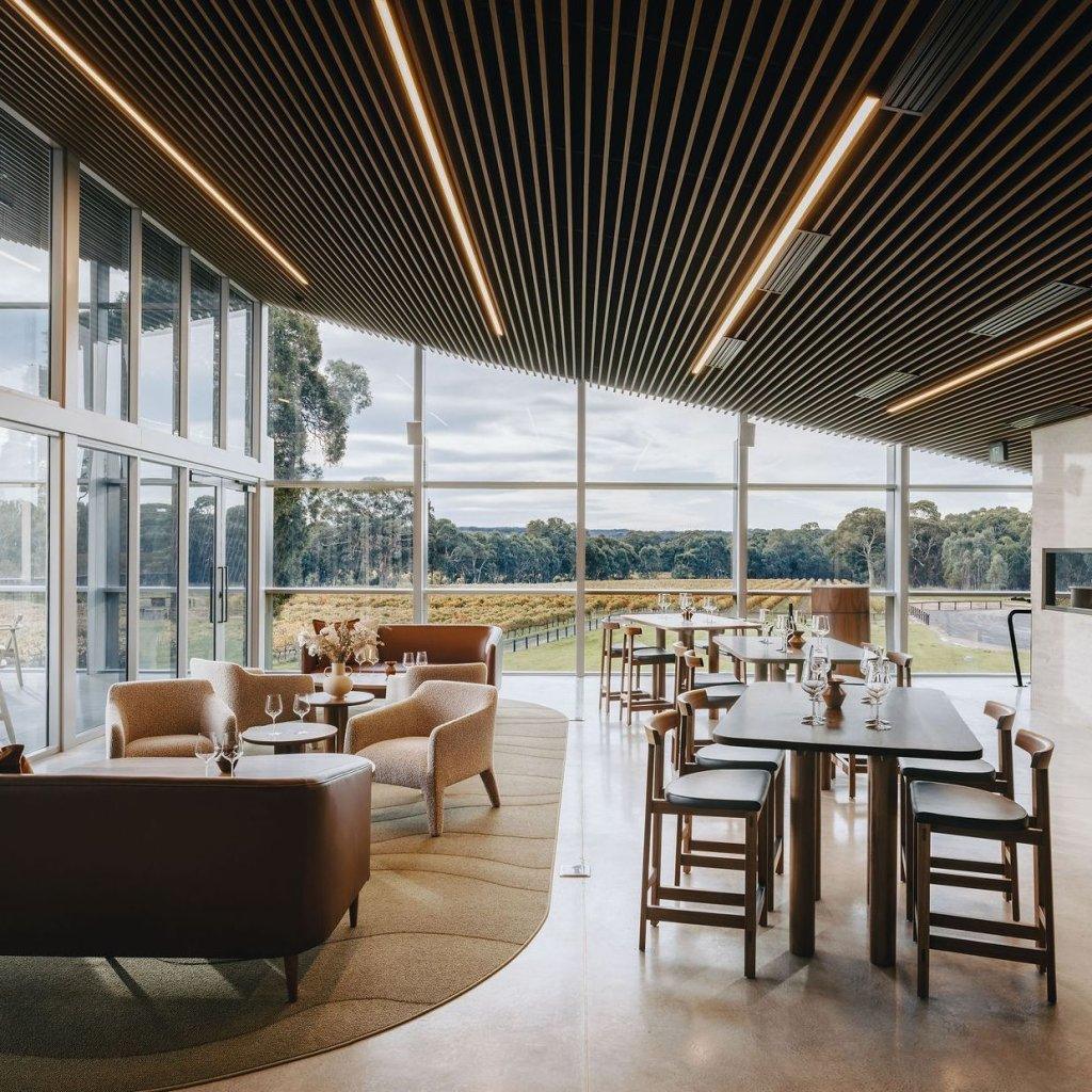 Yangarra Estate Vineyard Tasting room with high end architectural finish and furnishings high and low tables chairs and couches with a view over vineyards