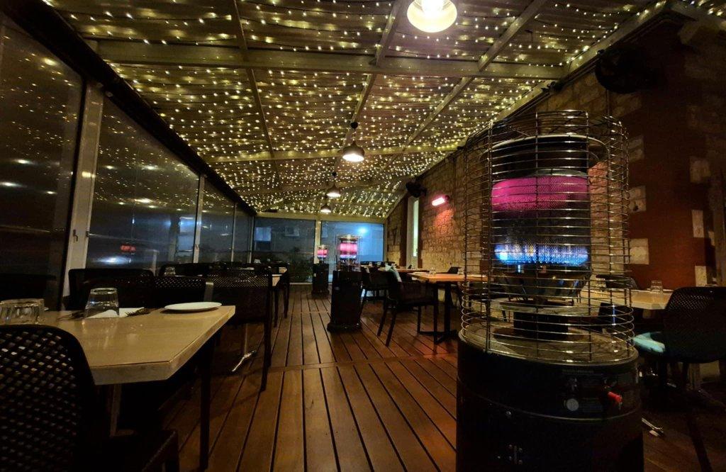 Vasarelli Cellar Door Restaurant enclosed outdoor deck with set tables at night