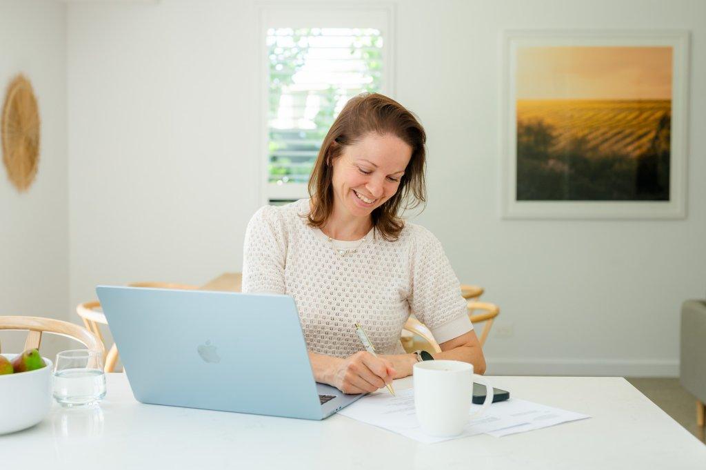 Woman working with her laptop on the kitchen bench at Vale 194 in McLaren Vale