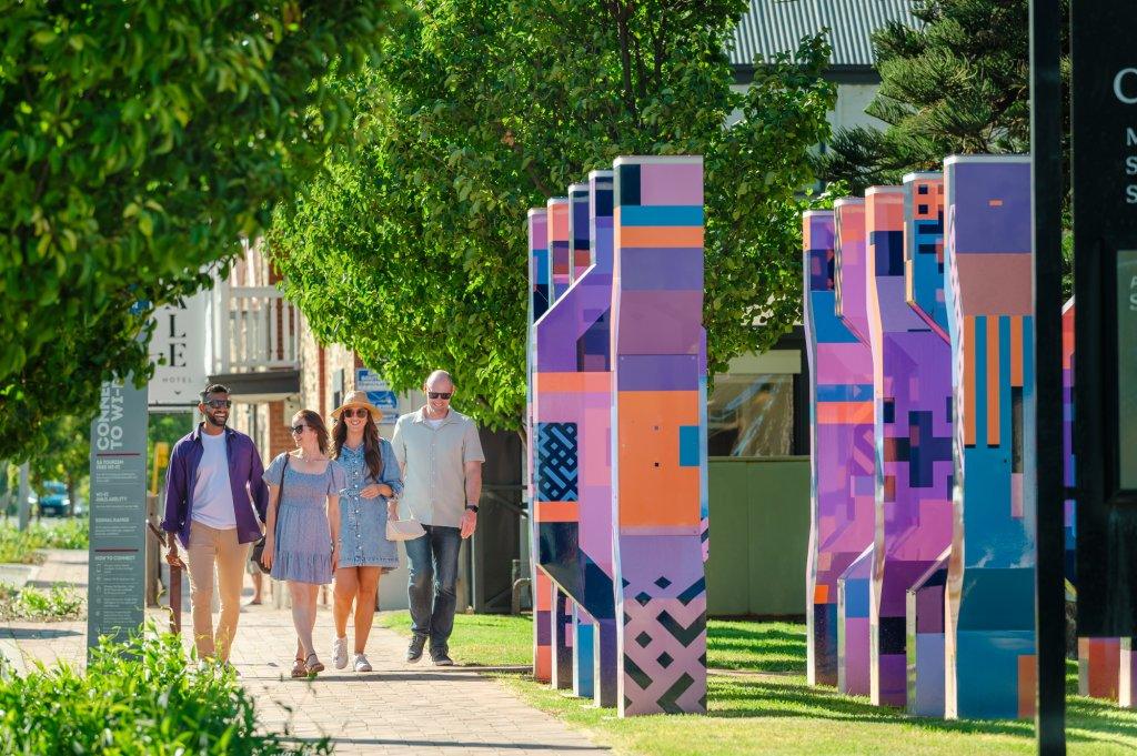 Main Road McLaren Vale with the Mclaren Vale hotel in the back ground and colourful sculptures in the foreground.